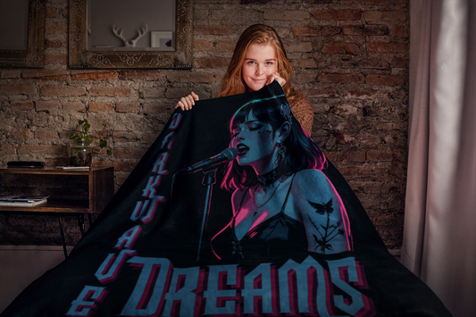 Person holding a plush blanket with a graphic design of a gothic woman singing in neon lights