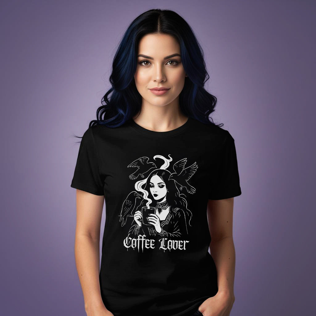 Woman wearing a gothic black t-shirt with a graphic design of a woman with coffee cup, surrounded by birds and text 'coffee lover'