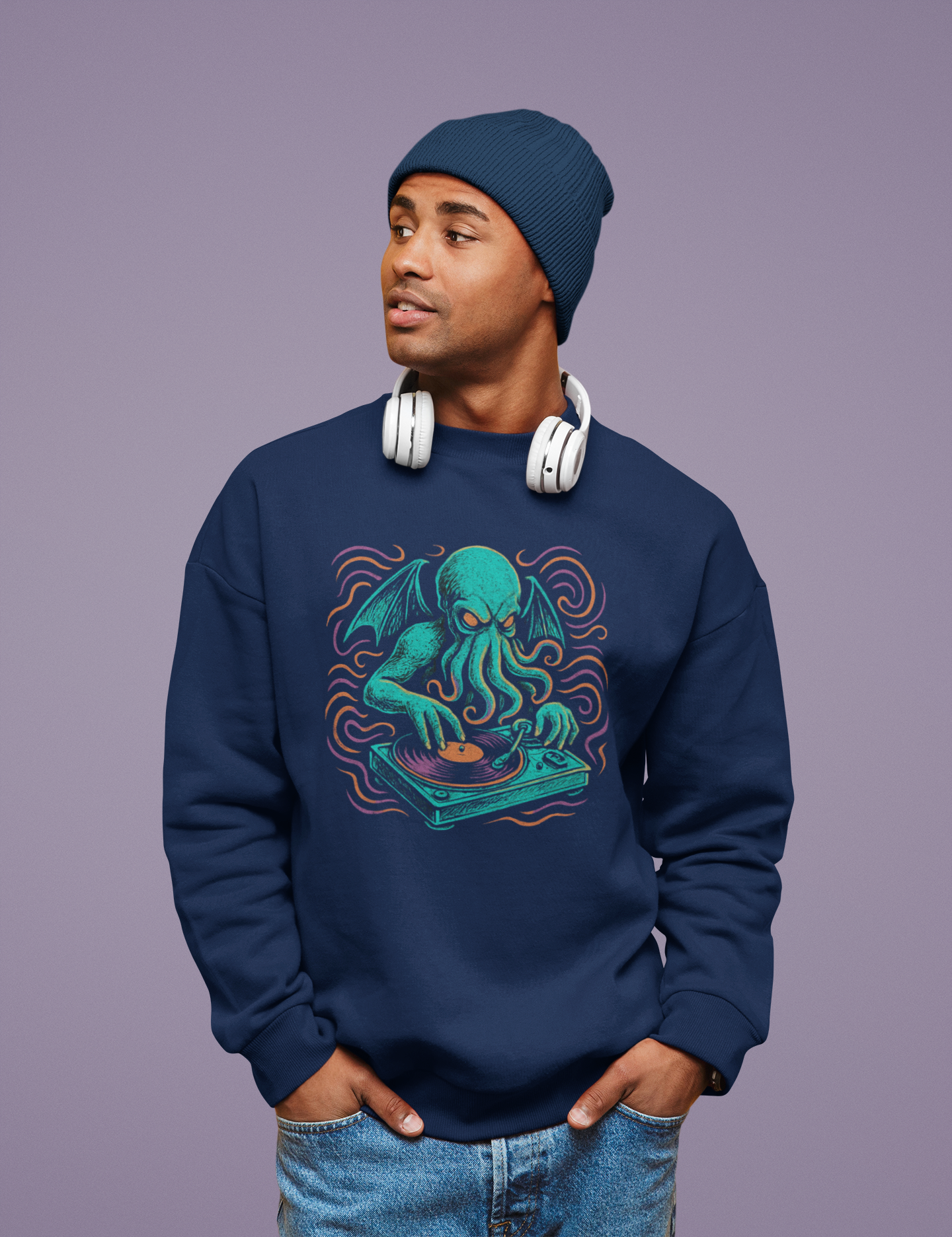 Man wearing a navy sweatshirt with a graphic design of an octopus Cthulhu as a DJ, standing against a purple background.
