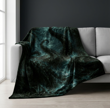 Velveteen blanket with dark tentacles design draped over a gray sofa in a room with large windows.