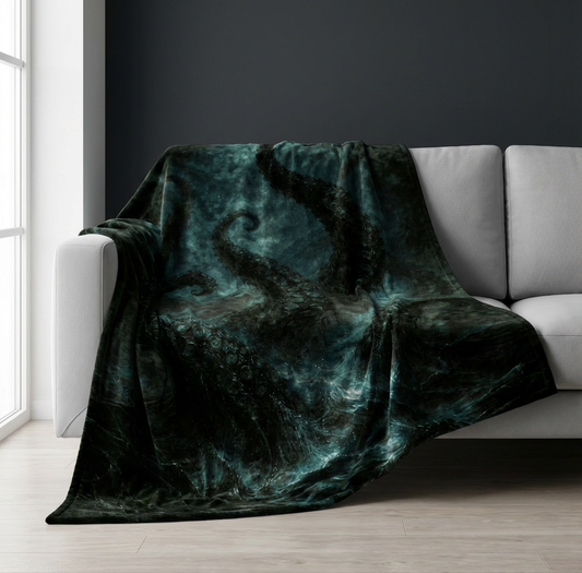 Velveteen blanket with dark tentacles design draped over a gray sofa in a room with large windows.