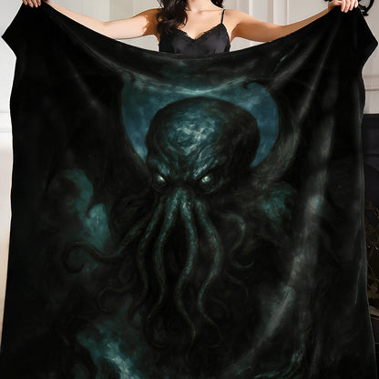 Person holding a black blanket with a dark painterly Cthulhu design