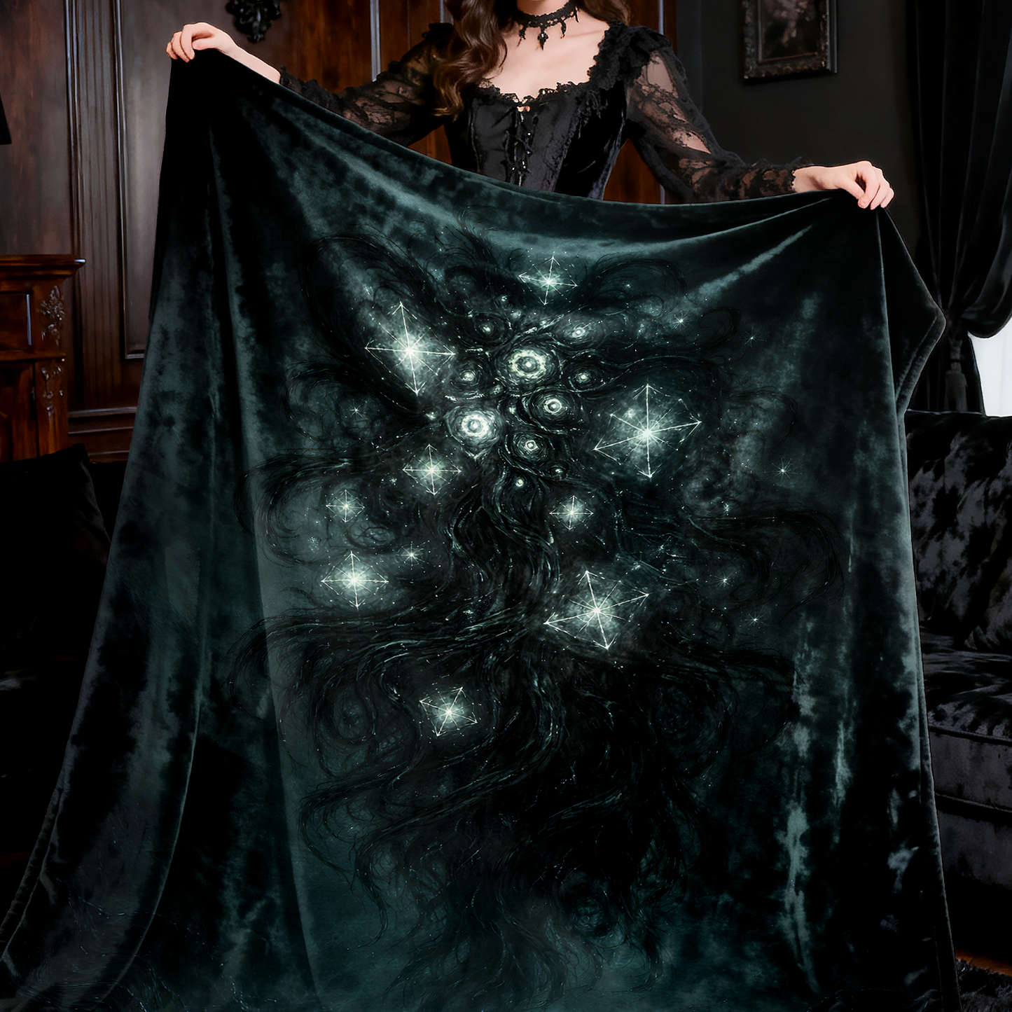 Person holding a dark blanket with lovecraft yog-sothoth design